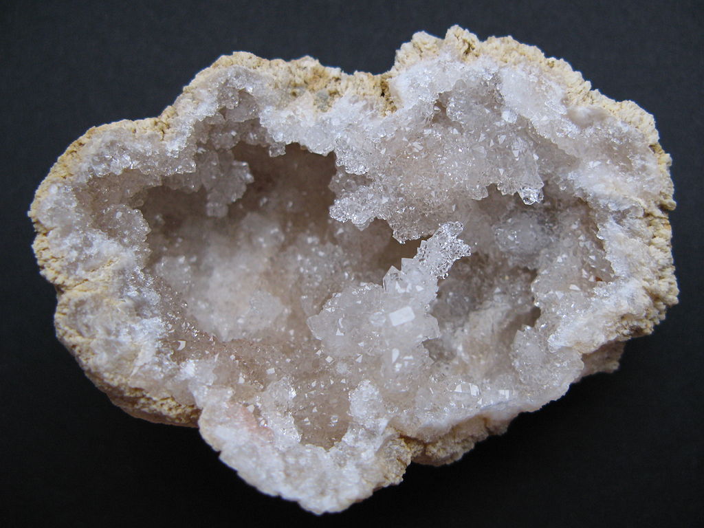 Geodes may be drab on the surface, but these rocks are full of crystallized minerals on the inside. [Image Credit: <a href="http://commons.wikimedia.org/wiki/File:Quartz_geode_from_Morocco.JPG">iRocks.com</a> via Wikimedia Commons]